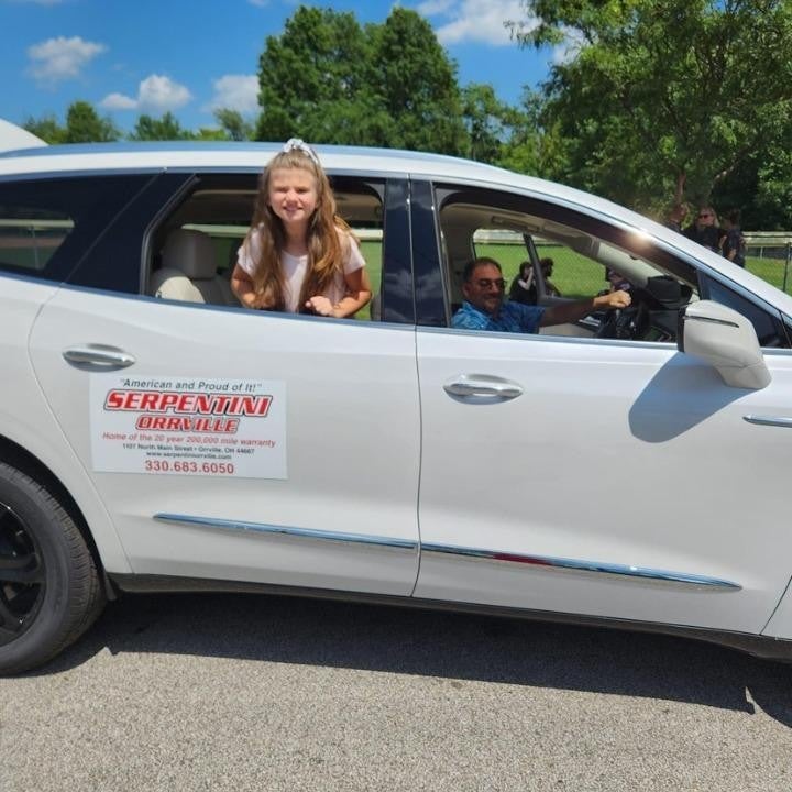 Man in car, girl gazing out the window