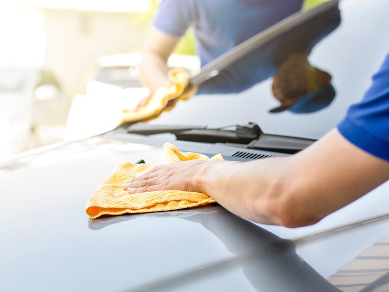 Cleaning a car with a cloth